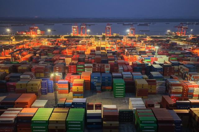Containers and ships are seen at the port in Nanjing, in China’s eastern Jingsu province early on June 9, 2026. China's exports to the United States surged 35.4 percent year-on-year last month, official data showed on June 9, 2026, weeks after President Donald Trump visited Beijing with trade high on the agenda. (Photo by CN-STR / AFP) / China OUT