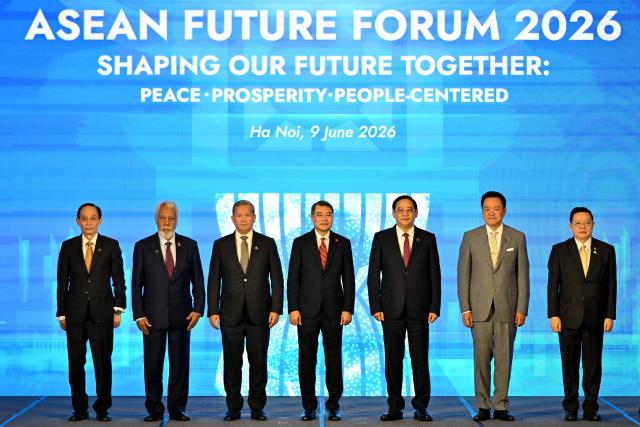 (L-R) Vietnam's Minister of Foreign Affairs Le Hoai Trung, East Timor's Prime Minister Xanana Gusmao, Cambodia's Prime Minister Hun Manet, Vietnam's Prime Minister Le Minh Hung, Laos' Prime Minister Sonexay Siphandone, Thailand's Prime Minister Anutin Charnvirakul and Association of Southeast Asian Nations (ASEAN) Secretary General Kao Kim Hourn pose for a group photo at the ASEAN Future Forum 2026 at the Melia Hotel in Hanoi on June 9, 2026. (Photo by Nhac NGUYEN / AFP)