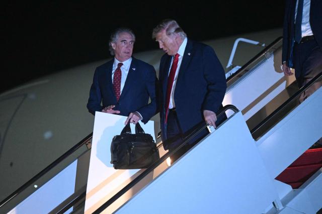 US Secretary of the Interior Doug Burgum and US President Donald Trump disembark from Air Force One upon arrival at Joint Base Andrews in Maryland, on June 9, 2026. Trump is returning to the White House after attending Game Three of the NBA Finals. (Photo by SAUL LOEB / AFP)
