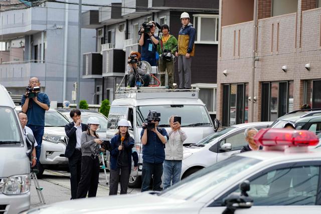 Members of the media watch as hunters and zoo staff search for a wild bear in Utsunomiya, north of Tokyo, on June 9, 2026. A bear roaming the streets of a Japanese city for days forced the closure of nearly 100 schools, as dozens of hunters and officials searched for the animal. (Photo by Yuichi YAMAZAKI / AFP)