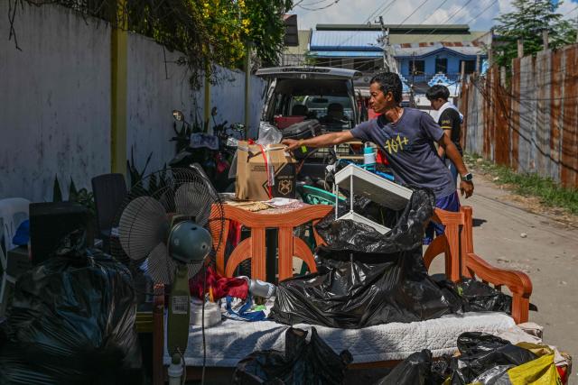 A resident gathers belongings after a 7.8 magnitude earthquake in General Santos City on June 9, 2026. A 7.8-magnitude earthquake in the southern Philippines on June 8 killed at least 35 people, according to provincial authorities, after toppling buildings and sparking tsunami warnings across the region. (Photo by Jam STA ROSA / AFP)