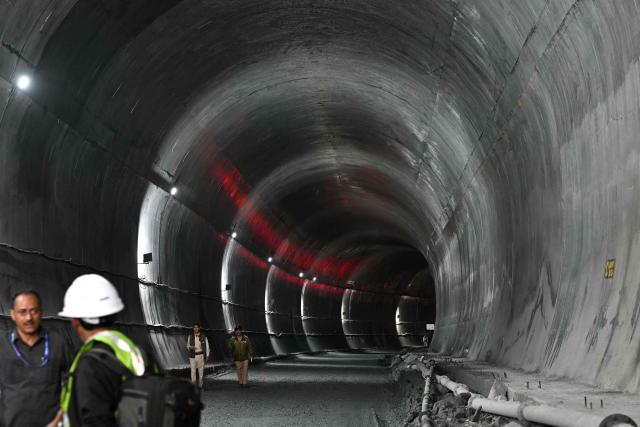 Indian police personnel stand guard at the Zojila tunnel, India's longest road tunnel project connecting Jammu and Kashmir state with the Ladakh region on June 9, 2026. (Photo by TAUSEEF MUSTAFA / AFP)