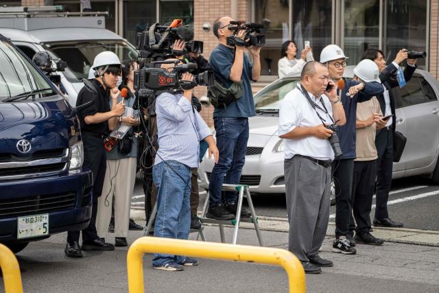 Members of the media watch as hunters and zoo staff search for a wild bear in Utsunomiya, north of Tokyo, on June 9, 2026. A bear roaming the streets of a Japanese city for days forced the closure of nearly 100 schools, as dozens of hunters and officials searched for the animal. (Photo by Yuichi YAMAZAKI / AFP)