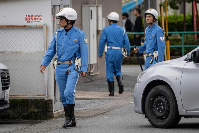 Police officers search for a wild bear in Utsunomiya, north of Tokyo, on June 9, 2026. A bear roaming the streets of a Japanese city for days forced the closure of nearly 100 schools, as dozens of hunters and officials searched for the animal. (Photo by Yuichi YAMAZAKI / AFP)