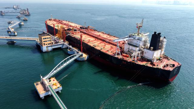This aerial photo shows a tanker unloading imported crude oil at a terminal port in Qingdao, in China’s eastern Shandong province on June 9, 2026. (Photo by CN-STR / AFP) / China OUT