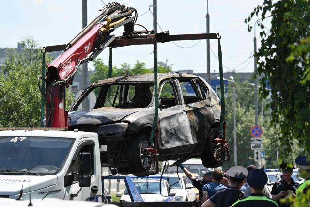 The wreckage of a car is loaded onto the platform of a truck after a blast caused by an explosive device killed its driver in Balashikha, outside Moscow, on June 9, 2026. (Photo by Igor IVANKO / AFP)