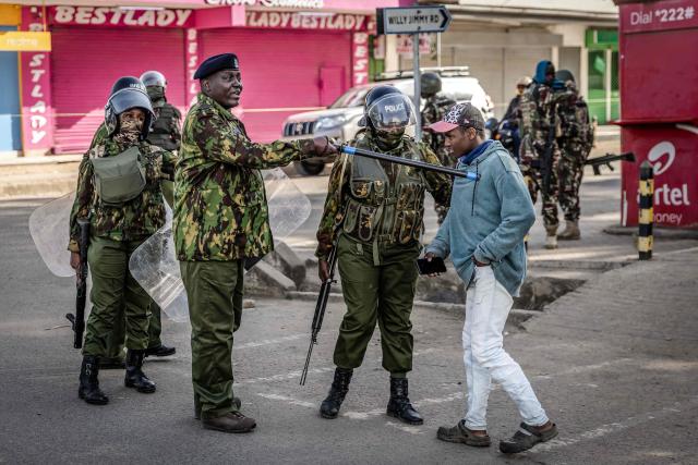 Kenyan police officers push a resident away as they monitor a street amid a heavy security deployment during a demonstration against a controversial US-built Ebola quarantine centre slated to begin operations at Laikipia Air Base in Nanyuki on June 9, 2026. Several Kenyans were arrested on June 9, 2026 in the latest protests against an Ebola quarantine centre being built for US citizens in a tourist town.
The centre at Laikipia Air Base in the town of Nanyuki, under the shadow of Mount Kenya, is set to quarantine Americans arriving from the Democratic Republic of Congo (DRC), which is battling a major Ebola outbreak. (Photo by Luis TATO / AFP)