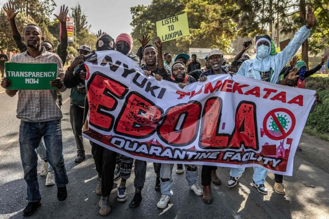Protesters hold a banner and chant slogans as they march during a demonstration against a controversial US-built Ebola quarantine centre slated to begin operations at Laikipia Air Base in Nanyuki on June 9, 2026. Several Kenyans were arrested on June 9, 2026 in the latest protests against an Ebola quarantine centre being built for US citizens in a tourist town.
The centre at Laikipia Air Base in the town of Nanyuki, under the shadow of Mount Kenya, is set to quarantine Americans arriving from the Democratic Republic of Congo (DRC), which is battling a major Ebola outbreak. (Photo by Luis TATO / AFP)