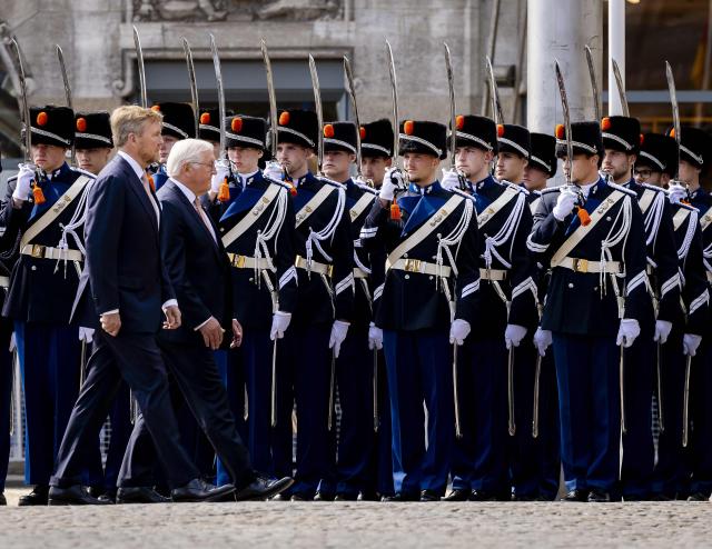 Netherlands' King Willem-Alexander (L) and German President Frank-Walter Steinmeier review troops as they arrive at Dam Square in Amsterdam on June 9, 2026. German President Frank-Walter Steinmeier is paying a three-day state visit to the Netherlands. (Photo by Remko de Waal / ANP / AFP) / Netherlands OUT