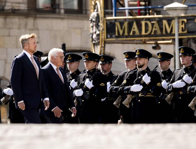 Netherlands' King Willem-Alexander (L) and German President Frank-Walter Steinmeier review troops as they arrive at Dam Square in Amsterdam on June 9, 2026. German President Frank-Walter Steinmeier is paying a three-day state visit to the Netherlands. (Photo by Remko de Waal / ANP / AFP) / Netherlands OUT