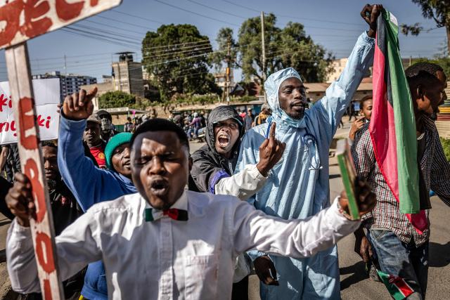 TOPSHOT - Protesters chant slogans as they march during a demonstration against a controversial US-built Ebola quarantine centre slated to begin operations at Laikipia Air Base in Nanyuki on June 9, 2026. Several Kenyans were arrested on June 9, 2026 in the latest protests against an Ebola quarantine centre being built for US citizens in a tourist town.
The centre at Laikipia Air Base in the town of Nanyuki, under the shadow of Mount Kenya, is set to quarantine Americans arriving from the Democratic Republic of Congo (DRC), which is battling a major Ebola outbreak. (Photo by Luis TATO / AFP)