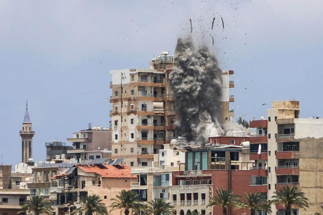 TOPSHOT - Smoke and debris rise following an Israeli airstrike in Tyre on June 9, 2026. Residents of south Lebanon's Tyre including the Christian quarter fled on June 9, an AFP correspondent said, after Israel's army for the first time warned the entire city to evacuate ahead of strikes. The warning came a day after Iran, which insists a halt to the wider Middle East conflict must include a ceasefire in Lebanon, warned it would resume attacks on Israel if it kept striking its neighbour. (Photo by KAWANT HAJU / AFP) / 