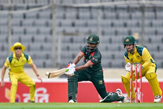 Bangladesh's Mosaddek Hossain (C) plays a shot as Australia's wicketkeeper and captain Josh Inglis (R) watches during the first one-day international (ODI) cricket match between Bangladesh and Australia at the Sher-e-Bangla National Cricket Stadium in Dhaka on June 9, 2026. (Photo by Munir UZ ZAMAN / AFP)