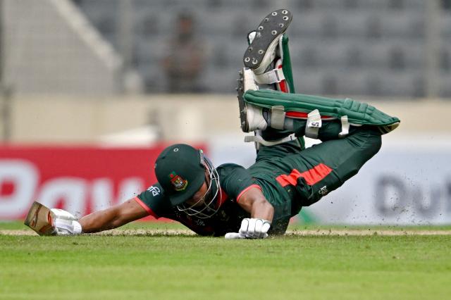 Bangladesh's Taskin Ahmed dives to reach the crease during the first one-day international (ODI) cricket match between Bangladesh and Australia at the Sher-e-Bangla National Cricket Stadium in Dhaka on June 9, 2026. (Photo by Munir UZ ZAMAN / AFP)