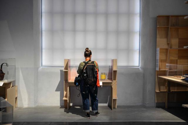 A visitor takes part in the press preview at the Galerie Nationale du Design on the eve of its opening in the heart of the Cite du design in Saint-Etienne on June 9, 2026. This unique venue in France is dedicated to promoting French public design collections. (Photo by OLIVIER CHASSIGNOLE / AFP)