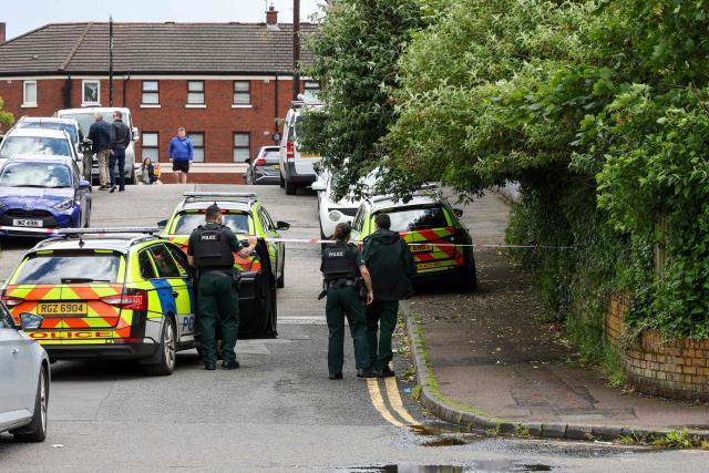 Police work  at the scene of a stabbing on Kinnaird Avenue in north Belfast, Northern Ireland, on June 9, 2026. Northern Ireland police said Tuesday they had arrested a man following a "stabbing incident" in Belfast, with graphic online video prompting widespread condemnation and protest calls from UK far-right figures. The Police Service of Northern Ireland (PSNI) said the arrested man was in his 30s, believed to be Somali, and had been detained on suspicion of attempted murder following the "serious assault involving a knife". (Photo by Paul Faith / AFP)