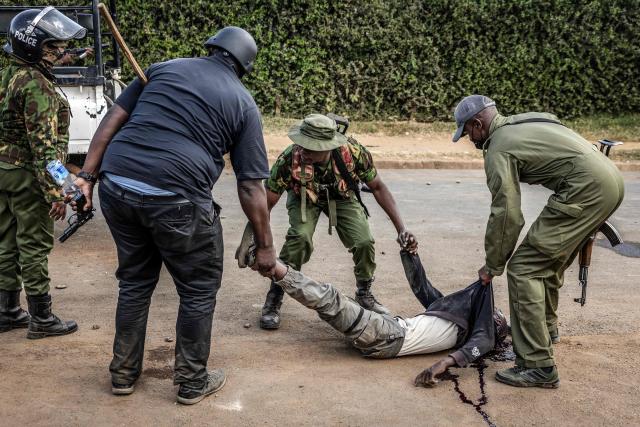 EDITORS NOTE: Graphic content / TOPSHOT - Kenya police officers carry a motionless seriously injured demonstrator as clashes erupt with protesters during a demonstration against a controversial US-built Ebola quarantine centre slated to begin operations at Laikipia Air Base in Nanyuki on June 9, 2026. Several Kenyans were arrested on June 9, 2026 in the latest protests against an Ebola quarantine centre being built for US citizens in a tourist town.
The centre at Laikipia Air Base in the town of Nanyuki, under the shadow of Mount Kenya, is set to quarantine Americans arriving from the Democratic Republic of Congo (DRC), which is battling a major Ebola outbreak. (Photo by Luis TATO / AFP)