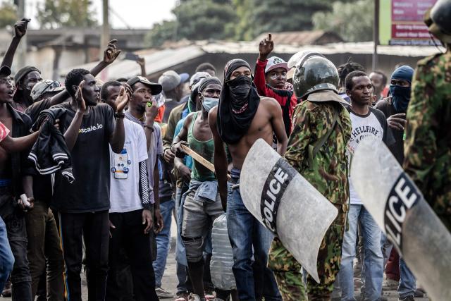 EDITORS NOTE: Graphic content / Demonstrators chant slogans as they confront Kenyan police officers during clashes at a demonstration against a controversial US-built Ebola quarantine centre slated to begin operations at Laikipia Air Base in Nanyuki on June 9, 2026. Several Kenyans were arrested on June 9, 2026 in the latest protests against an Ebola quarantine centre being built for US citizens in a tourist town.
The centre at Laikipia Air Base in the town of Nanyuki, under the shadow of Mount Kenya, is set to quarantine Americans arriving from the Democratic Republic of Congo (DRC), which is battling a major Ebola outbreak. (Photo by Luis TATO / AFP)
