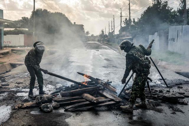 EDITORS NOTE: Graphic content / A Kenyan police officers remove burning barricades from a road during clashes with protesters at a demonstration against a controversial US-built Ebola quarantine centre slated to begin operations at Laikipia Air Base in Nanyuki on June 9, 2026. Several Kenyans were arrested on June 9, 2026 in the latest protests against an Ebola quarantine centre being built for US citizens in a tourist town.
The centre at Laikipia Air Base in the town of Nanyuki, under the shadow of Mount Kenya, is set to quarantine Americans arriving from the Democratic Republic of Congo (DRC), which is battling a major Ebola outbreak. (Photo by Luis TATO / AFP)