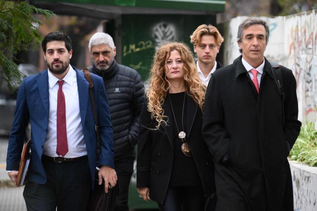Medical doctor Nancy Forlini (C), charged in the case of death of Argentine football legend Diego Maradona, arrives next to her lawers Agustin Varela (L) and Nicolas D'Albora (R) at the court for a trial hearing in San Isidro, Buenos Aires province, Argentina on June 9, 2026. (Photo by Luis ROBAYO / AFP)