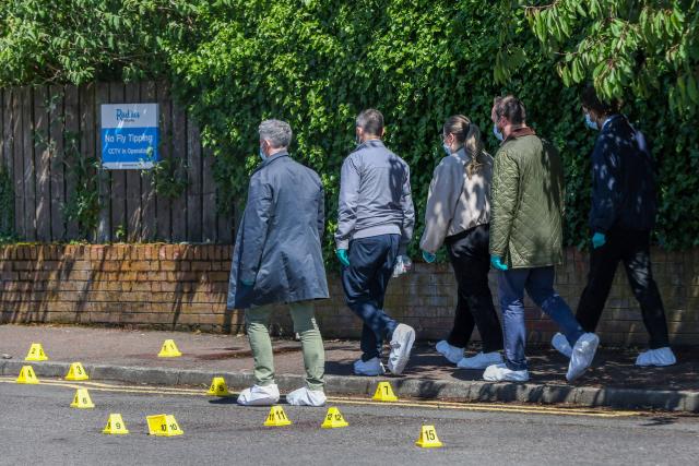 Police officers search the scene of a stabbing on Kinnaird Avenue in north Belfast, Northern Ireland, on June 9, 2026. Northern Ireland police said on June 9, 2026 they had arrested a man following what Prime Minister Keir Starmer branded a "sickening" stabbing in Belfast, with graphic video prompting protest calls from UK far-right figures. Video of the June 8, 2026 incident posted on social media networks shows a man straddling another man lying in a street and slashing him several times in the head and neck with a knife in what appears to be an attempted beheading. (Photo by Paul Faith / AFP)