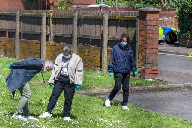 Police officers search the scene of a stabbing on Kinnaird Avenue in north Belfast, Northern Ireland, on June 9, 2026. Northern Ireland police said on June 9, 2026 they had arrested a man following what Prime Minister Keir Starmer branded a "sickening" stabbing in Belfast, with graphic video prompting protest calls from UK far-right figures. Video of the June 8, 2026 incident posted on social media networks shows a man straddling another man lying in a street and slashing him several times in the head and neck with a knife in what appears to be an attempted beheading. (Photo by Paul Faith / AFP)