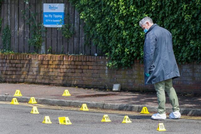 Police officers search the scene of a stabbing on Kinnaird Avenue in north Belfast, Northern Ireland, on June 9, 2026. Northern Ireland police said on June 9, 2026 they had arrested a man following what Prime Minister Keir Starmer branded a "sickening" stabbing in Belfast, with graphic video prompting protest calls from UK far-right figures. Video of the June 8, 2026 incident posted on social media networks shows a man straddling another man lying in a street and slashing him several times in the head and neck with a knife in what appears to be an attempted beheading. (Photo by Paul Faith / AFP)