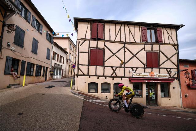 EF Education - EasyPost's French rider Alex Baudin wearing the overall leader's yellow jersey cycles during the 3rd stage of the Tour Auvergne-Rhone-Alpes cycling race (formerly known as the Criterium du Dauphine), 28,4km team time trial departing and arriving in Perreux central France, on June 9, 2026. (Photo by Anne-Christine POUJOULAT / AFP)