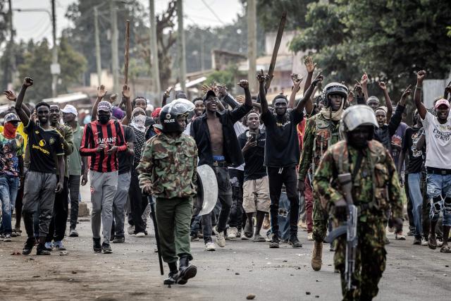 Demonstrators celebrate as Kenyan police officers withdraw during clashes at a demonstration against a controversial US-built Ebola quarantine centre slated to begin operations at Laikipia Air Base in Nanyuki on June 9, 2026. Several Kenyans were arrested on June 9, 2026 in the latest protests against an Ebola quarantine centre being built for US citizens in a tourist town.
The centre at Laikipia Air Base in the town of Nanyuki, under the shadow of Mount Kenya, is set to quarantine Americans arriving from the Democratic Republic of Congo (DRC), which is battling a major Ebola outbreak. (Photo by Luis TATO / AFP)