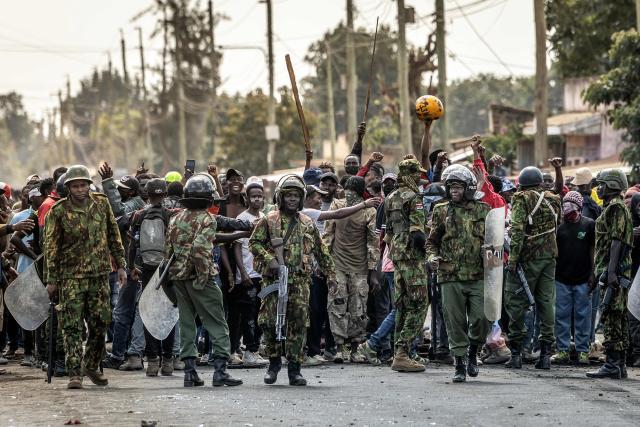 Demonstrators celebrate as Kenyan police officers withdraw during clashes at a demonstration against a controversial US-built Ebola quarantine centre slated to begin operations at Laikipia Air Base in Nanyuki on June 9, 2026. Several Kenyans were arrested on June 9, 2026 in the latest protests against an Ebola quarantine centre being built for US citizens in a tourist town.
The centre at Laikipia Air Base in the town of Nanyuki, under the shadow of Mount Kenya, is set to quarantine Americans arriving from the Democratic Republic of Congo (DRC), which is battling a major Ebola outbreak. (Photo by Luis TATO / AFP)