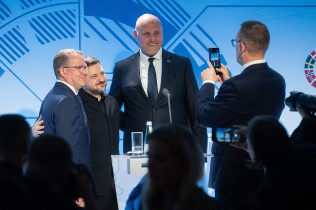 Estonia's Prime Minister Kristen Michal (R) takes a photo of (L-R) Finland's Prime Minister Petteri Orpo, Ukrainian President Volodymyr Zelensky and Latvia's Prime Minister Andris Kulbergs posing for a photo at the end of a joint press conference during the Nordic and Baltic Prime Ministers (NB8) Summit 2026 at the Stenbock House (Statehood House) in Tallinn, Estonia on June 9, 2026. The Nordic-Baltic leaders declared support to Ukraine's "irreversible path" to NATO membership, after a summit on June 9 in Tallinn with President Zelensky. (Photo by RAIGO PAJULA / AFP)
