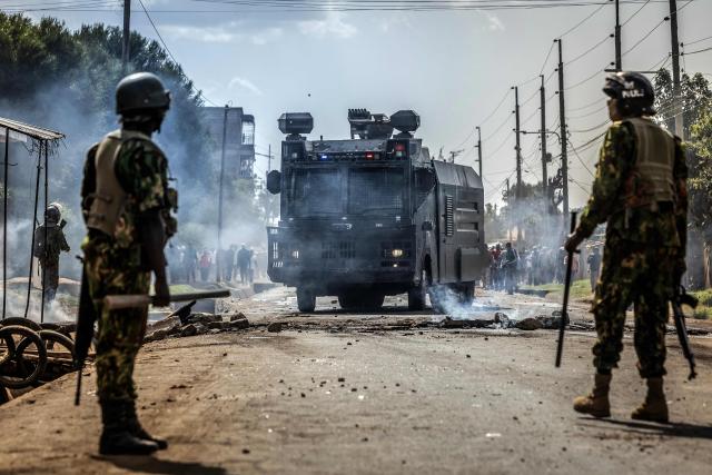 Kenyan police officers monitor a road as a police water cannon vehicle removes barricades during clashes with protesters at a demonstration against a controversial US-built Ebola quarantine centre slated to begin operations at Laikipia Air Base in Nanyuki on June 9, 2026. Several Kenyans were arrested on June 9, 2026 in the latest protests against an Ebola quarantine centre being built for US citizens in a tourist town.
The centre at Laikipia Air Base in the town of Nanyuki, under the shadow of Mount Kenya, is set to quarantine Americans arriving from the Democratic Republic of Congo (DRC), which is battling a major Ebola outbreak. (Photo by Luis TATO / AFP)