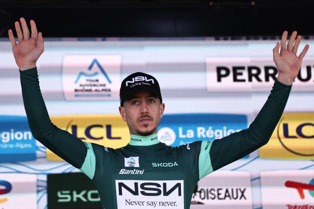 NSN Cycling Team's Israeli rider Nadav Raisberg celebrates on the podium wearing the sprinter's green jersey after during the 3rd stage of the Tour Auvergne-Rhone-Alpes cycling race (formerly known as the Criterium du Dauphine), 28,4km team time trial departing and arriving in Perreux central France, on June 9, 2026. (Photo by Anne-Christine POUJOULAT / AFP)