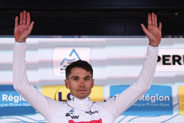 EF Education - EasyPost's French rider Alex Baudin celebrates on the podium wearing the best young rider's white jersey cycle after the 3rd stage of the Tour Auvergne-Rhone-Alpes cycling race (formerly known as the Criterium du Dauphine), 28,4km team time trial departing and arriving in Perreux central France, on June 9, 2026. (Photo by Anne-Christine POUJOULAT / AFP)