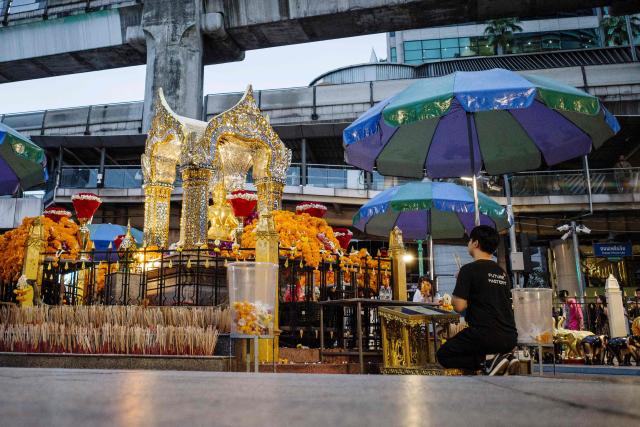 A visitor prays at the Buddhist Erawan Shrine in Bangkok on June 9, 2026. (Photo by ANTHONY WALLACE / AFP)
