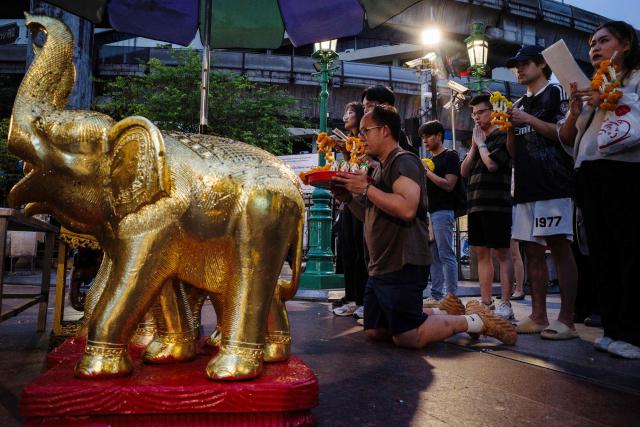 Visitors pray at the Buddhist Erawan Shrine in Bangkok on June 9, 2026. (Photo by ANTHONY WALLACE / AFP)