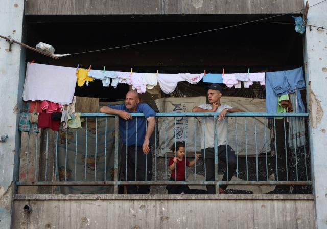 People watch Palestinians playing football inside a school sheltering displaced people at the Jabalia refugee camp in the northern Gaza Strip, on June 9, 2026. (Photo by Omar AL-QATTAA / AFP)