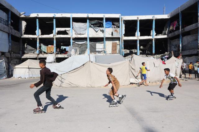 Palestinian boys skate at the Jabalia refugee camp in the northern Gaza Strip, on June 9, 2026. (Photo by Omar AL-QATTAA / AFP)