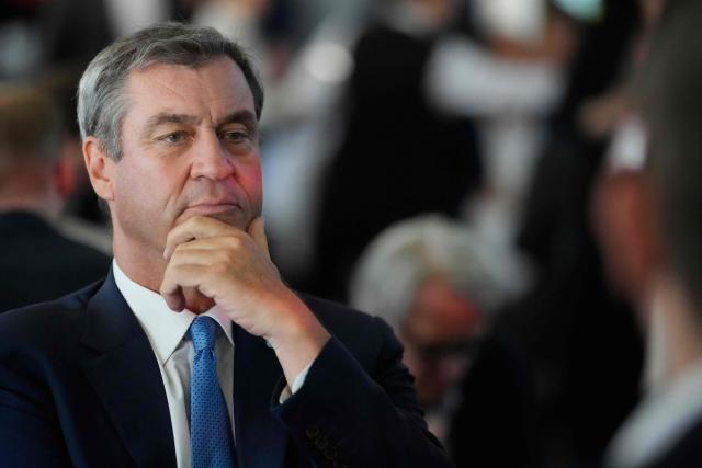 Bavaria's State Premier and leader of the conservative Christian Social Union (CSU) Markus Soeder listens to German Vice Chancellor and Finance Minister Lars Klingbeil at the Social Democratic Party's (SPD) 'Seeheimer Kreises Spargelfahrt' (Asparagus tour of the Seeheimer Group) in Berlin, on June 9, 2026. (Photo by Markus Schreiber / POOL / AFP)