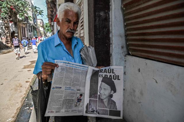A newspaper vendor displays a picture of former Cuba's President (2008-2018) Raul Castro on one of its pages in Havana on June 9, 2026 (Photo by YAMIL LAGE / AFP)