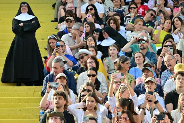 Faithfuls wait prior a prayer vigil at the Lluis Companys Olympic Stadium in Barcelona, on June 9, 2026. Pope Leo XIV is visiting Spain June 6-12 with stops in Madrid, Barcelona, and the Canary Islands, where he will meet with migrants and organisations dedicated to helping them. (Photo by Stefano RELLANDINI / AFP)