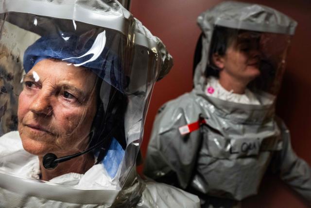 Two nurses in their PPE (Personal Protection Equipment) simulate the reception of a patient with a highly infectious disease such as Ebola, at the special isolation ward of the Department of Infectious Diseases at the Charite Virchow hospital in Berlin on June 9, 2026. The German hospital discharged a US man who caught Ebola in the Democratic Republic of Congo, after 17 days of antiviral treatment and medical care cured him of the often deadly infection. The Charite public hospital in Berlin said the man -- who had been working as a surgeon for a Christian missionary group in the DRC -- and his five family members who had all been in quarantine were in "good health" and permitted to leave. (Photo by John MACDOUGALL / AFP)