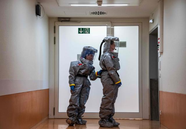 Two nurses in their PPE (Personal Protection Equipment) prepare to receive a patient with a highly infectious disease such as Ebola, during a simulation at the special isolation ward of the Department of Infectious Diseases at the Charite Virchow hospital in Berlin on June 9, 2026. The German hospital discharged a US man who caught Ebola in the Democratic Republic of Congo, after 17 days of antiviral treatment and medical care cured him of the often deadly infection. The Charite public hospital in Berlin said the man -- who had been working as a surgeon for a Christian missionary group in the DRC -- and his five family members who had all been in quarantine were in "good health" and permitted to leave. (Photo by John MACDOUGALL / AFP)
