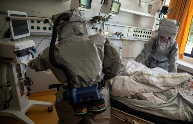 Two nurses in their PPE (Personal Protection Equipment) install a patient with a highly infectious disease such as Ebola, during a simulation at the special isolation ward of the Department of Infectious Diseases at the Charite Virchow hospital in Berlin on June 9, 2026. The German hospital discharged a US man who caught Ebola in the Democratic Republic of Congo, after 17 days of antiviral treatment and medical care cured him of the often deadly infection. The Charite public hospital in Berlin said the man -- who had been working as a surgeon for a Christian missionary group in the DRC -- and his five family members who had all been in quarantine were in "good health" and permitted to leave. (Photo by John MACDOUGALL / AFP)