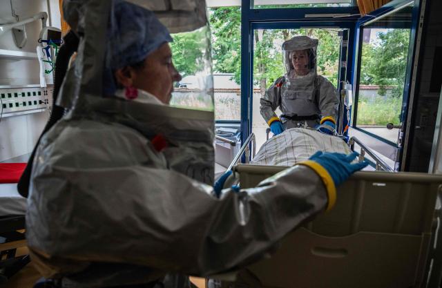 Two nurses in their PPE (Personal Protection Equipment) install a patient with a highly infectious disease such as Ebola, during a simulation at the special isolation ward of the Department of Infectious Diseases at the Charite Virchow hospital in Berlin on June 9, 2026. The German hospital discharged a US man who caught Ebola in the Democratic Republic of Congo, after 17 days of antiviral treatment and medical care cured him of the often deadly infection. The Charite public hospital in Berlin said the man -- who had been working as a surgeon for a Christian missionary group in the DRC -- and his five family members who had all been in quarantine were in "good health" and permitted to leave. (Photo by John MACDOUGALL / AFP)
