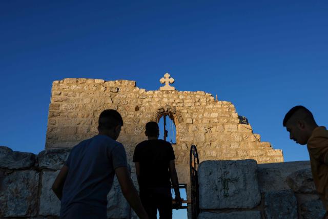 People visit the fifth-century Church of St George in the Palestinian Christian village of Taybeh, northeast of Ramallah, in the Israeli-occupied West Bank on June 9, 2026. (Photo by Zain JAAFAR / AFP)