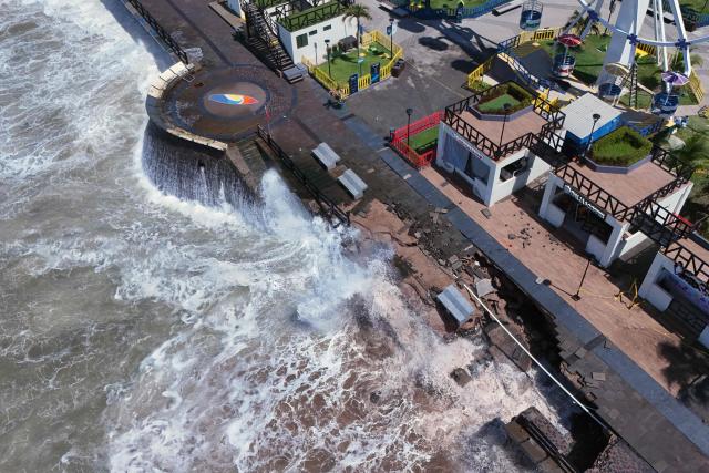 An aerial view shows rough seas near the port of La Libertad ahead of the arrival of Tropical Storm Cristina in La Libertad, El Salvador, on June 9, 2026. The approach of Tropical Storm Cristina on June 9 forced the closure of restaurants and the suspension of fishing activities in the port of La Libertad as part of measures taken by Salvadoran authorities ahead of possible severe weather conditions, according to AFP journalists. (Photo by Rudy QUIROZ / AFP)