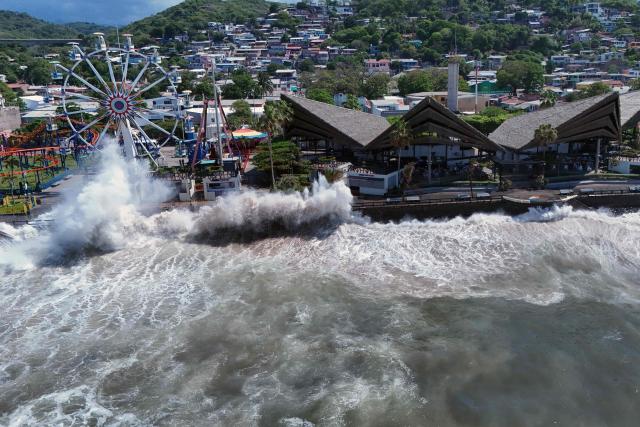 An aerial view shows rough seas near the port of La Libertad ahead of the arrival of Tropical Storm Cristina in La Libertad, El Salvador, on June 9, 2026. The approach of Tropical Storm Cristina on June 9 forced the closure of restaurants and the suspension of fishing activities in the port of La Libertad as part of measures taken by Salvadoran authorities ahead of possible severe weather conditions, according to AFP journalists. (Photo by Rudy QUIROZ / AFP)
