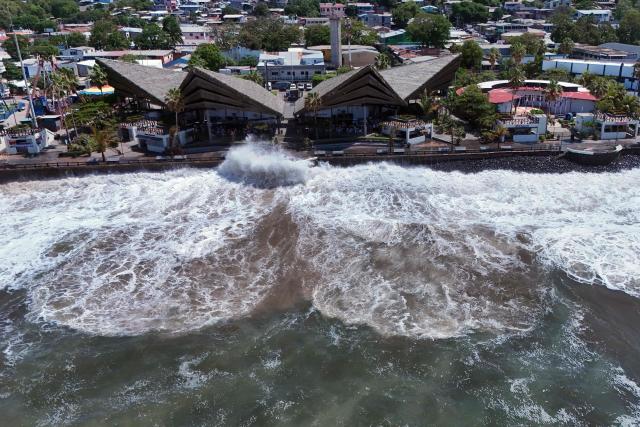 An aerial view shows rough seas near the port of La Libertad ahead of the arrival of Tropical Storm Cristina in La Libertad, El Salvador, on June 9, 2026. The approach of Tropical Storm Cristina on June 9 forced the closure of restaurants and the suspension of fishing activities in the port of La Libertad as part of measures taken by Salvadoran authorities ahead of possible severe weather conditions, according to AFP journalists. (Photo by Rudy QUIROZ / AFP)