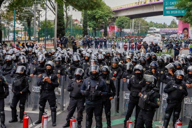 Members of the police block the way to the Ciudad de Mexico Stadium during a protest in Mexico City on June 9, 2026. Thousands of teachers blocked an avenue leading to the Azteca Stadium in Mexico City, 48 hours before the opening ceremony of the 2026 World Cup at that venue. (Photo by Gerardo Magallon / AFP)